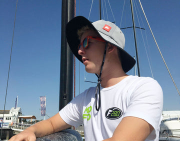 sailor wearing grey wide brimmed hat
